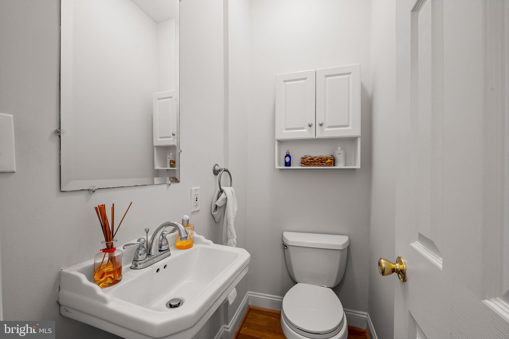 61 East Heath Street Baltimore, MD 21230 - Photo 17 of 30 a bathroom with a sink a toilet and mirror