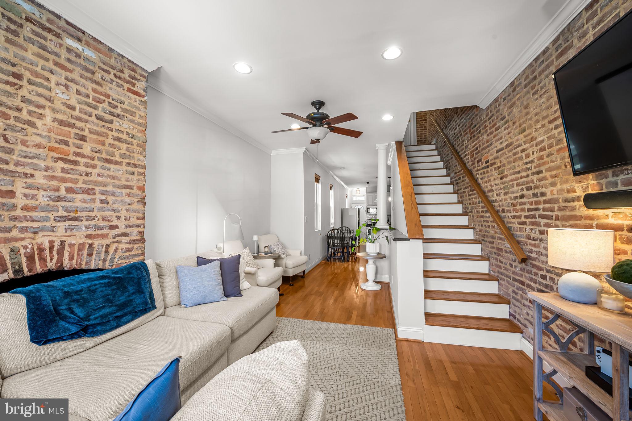 61 East Heath Street Baltimore, MD 21230 - Photo 4 of 30 a living room with furniture a flat screen tv and a fireplace