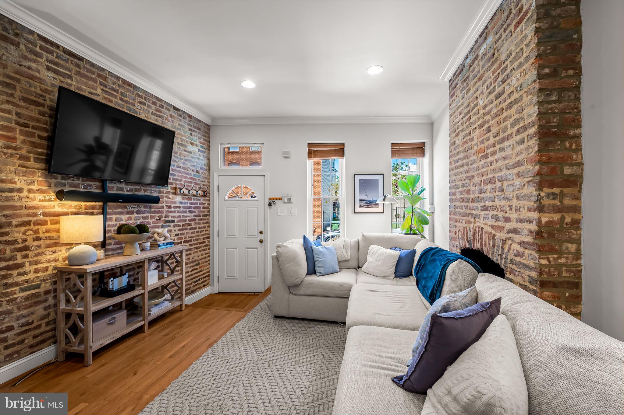 61 East Heath Street Baltimore, MD 21230 - Photo 6 of 30 a living room with furniture and a flat screen tv