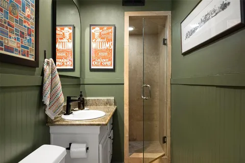 a bathroom with a toilet sink and mirror