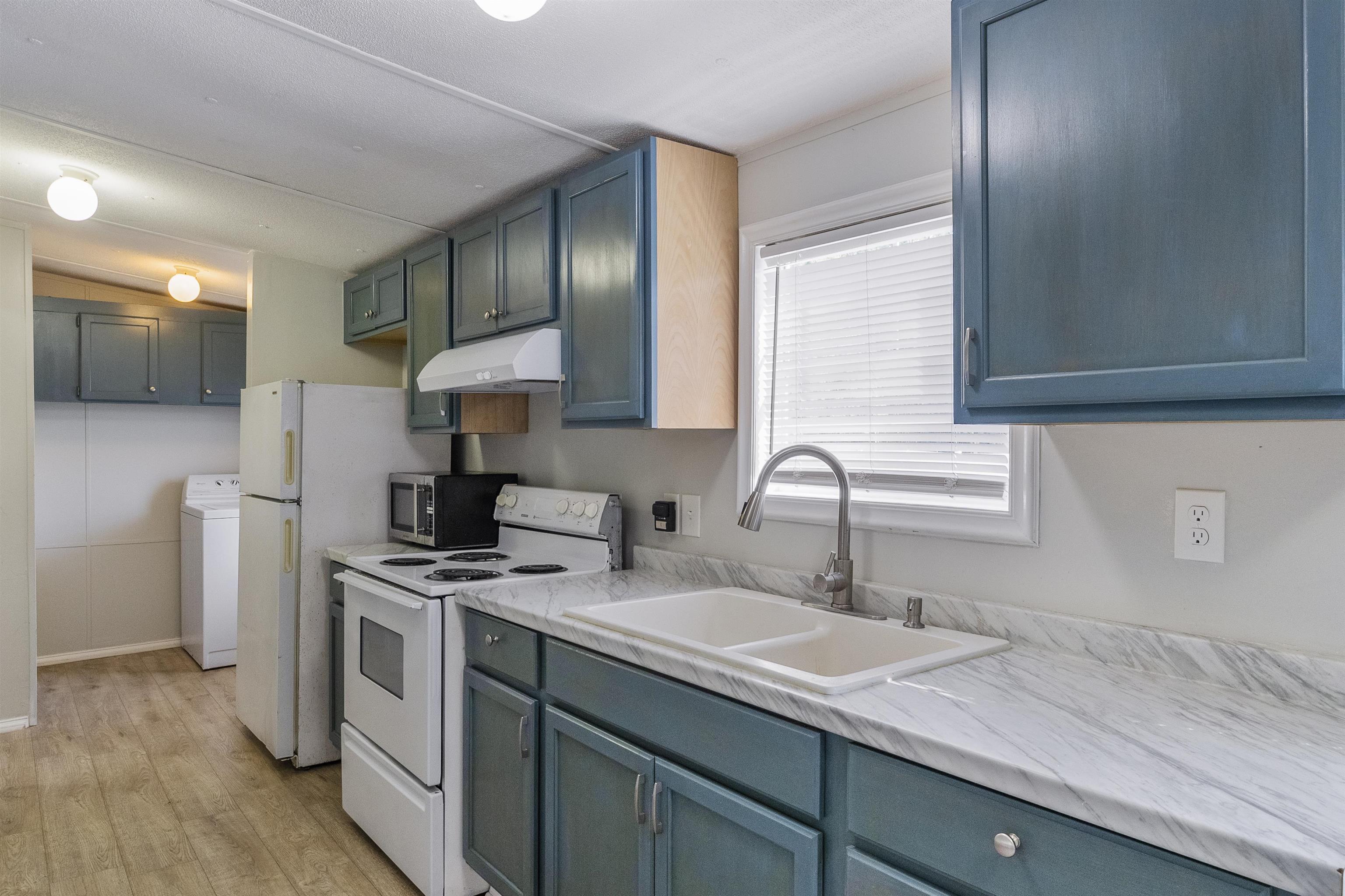2905 County Road 214, Unit D St. Augustine, FL 32084 - Photo 15 of 46 a kitchen with a sink cabinets and a wooden floor