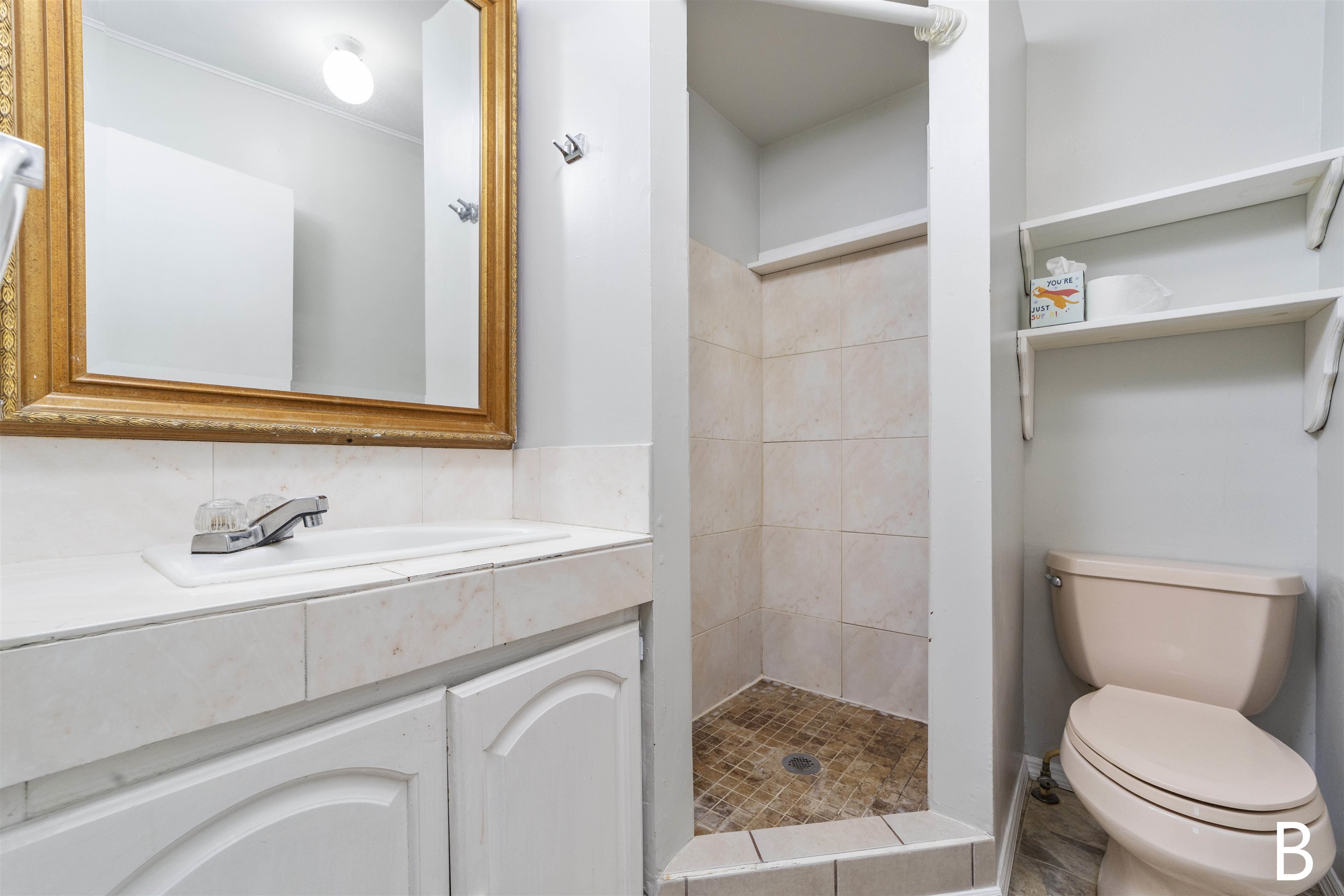 2905 County Road 214, Unit D St. Augustine, FL 32084 - Photo 19 of 46 a bathroom with a toilet sink vanity and mirror
