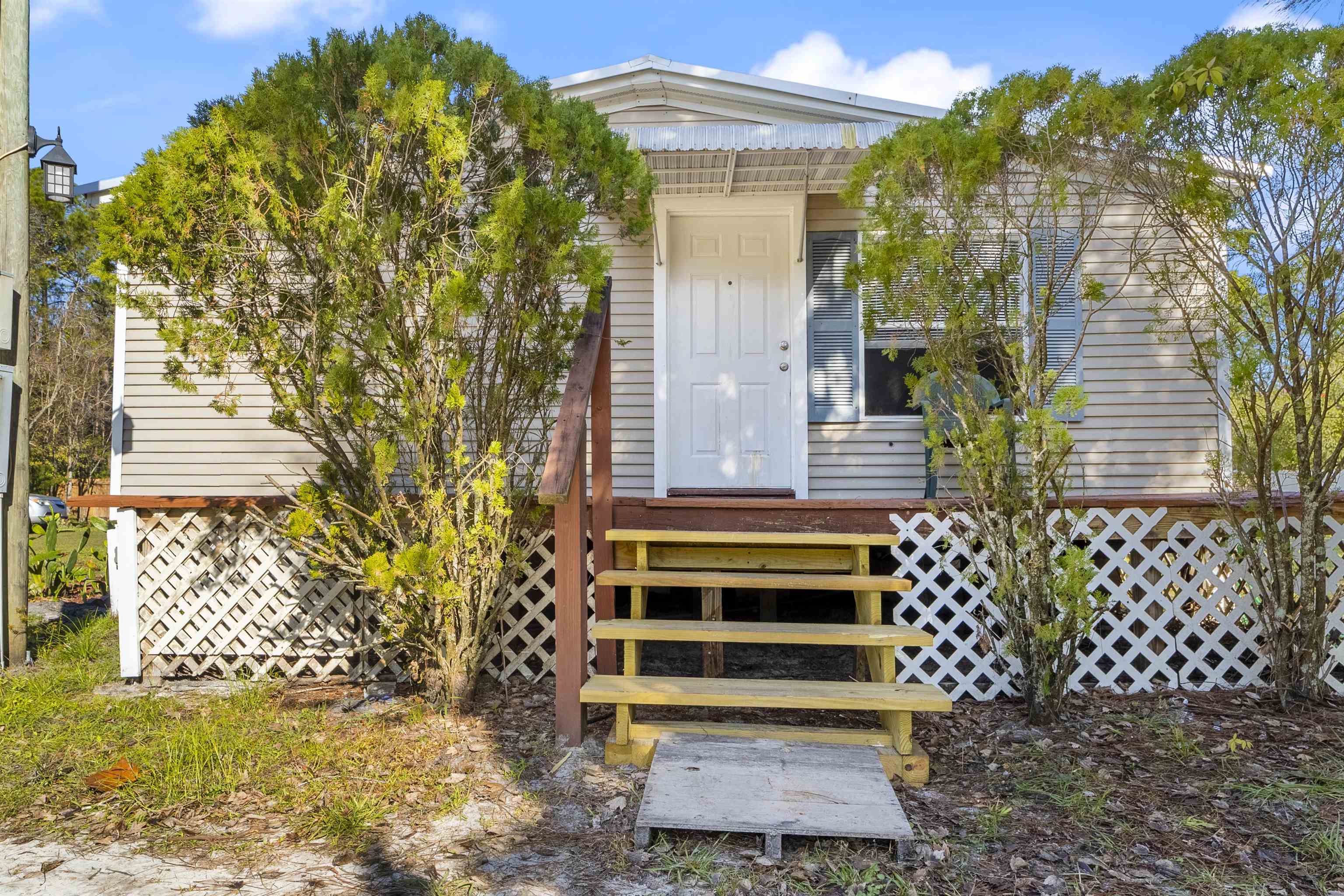 2905 County Road 214, Unit D St. Augustine, FL 32084 - Photo 22 of 46 a front view of a house with a yard