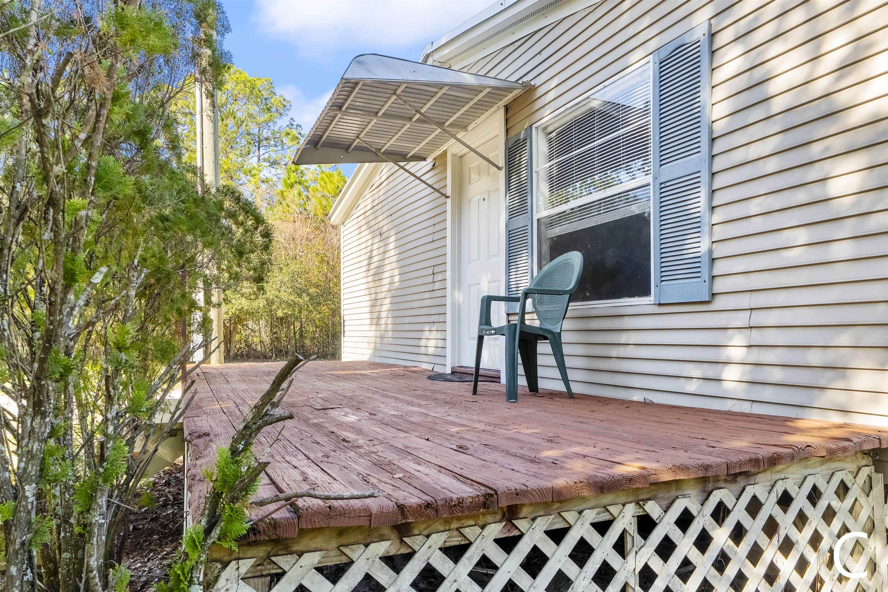 2905 County Road 214, Unit D St. Augustine, FL 32084 - Photo 24 of 46 a view of a patio with table and chairs with wooden floor and fence