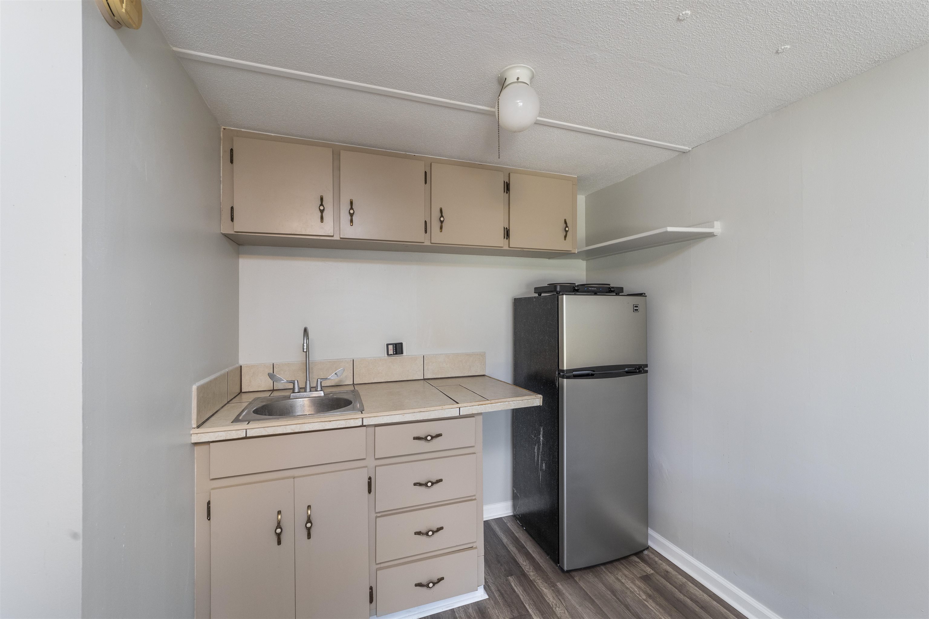 2905 County Road 214, Unit D St. Augustine, FL 32084 - Photo 30 of 46 a kitchen with sink cabinets and refrigerator