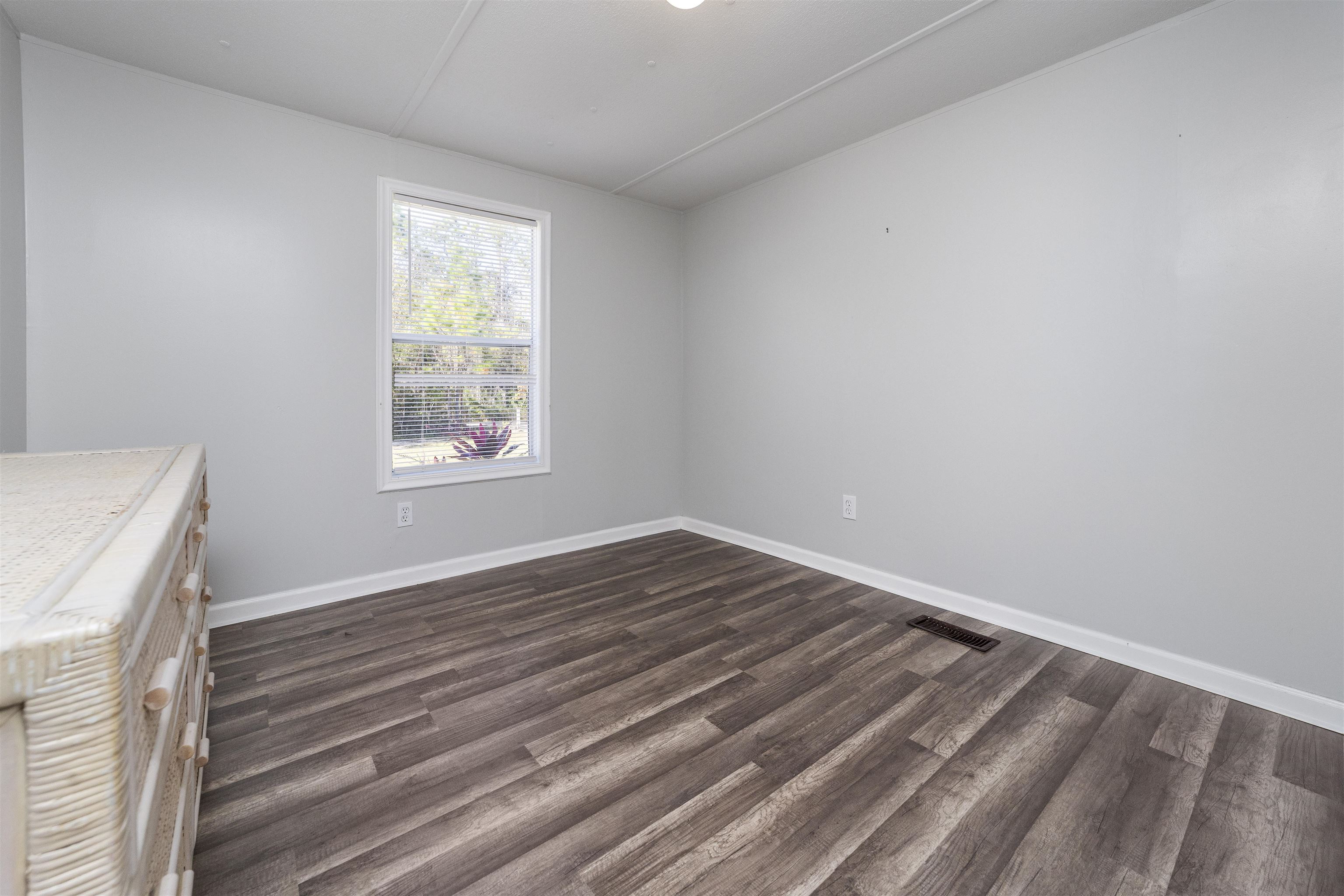 2905 County Road 214, Unit D St. Augustine, FL 32084 - Photo 31 of 46 a view of empty room with wooden floor and fan