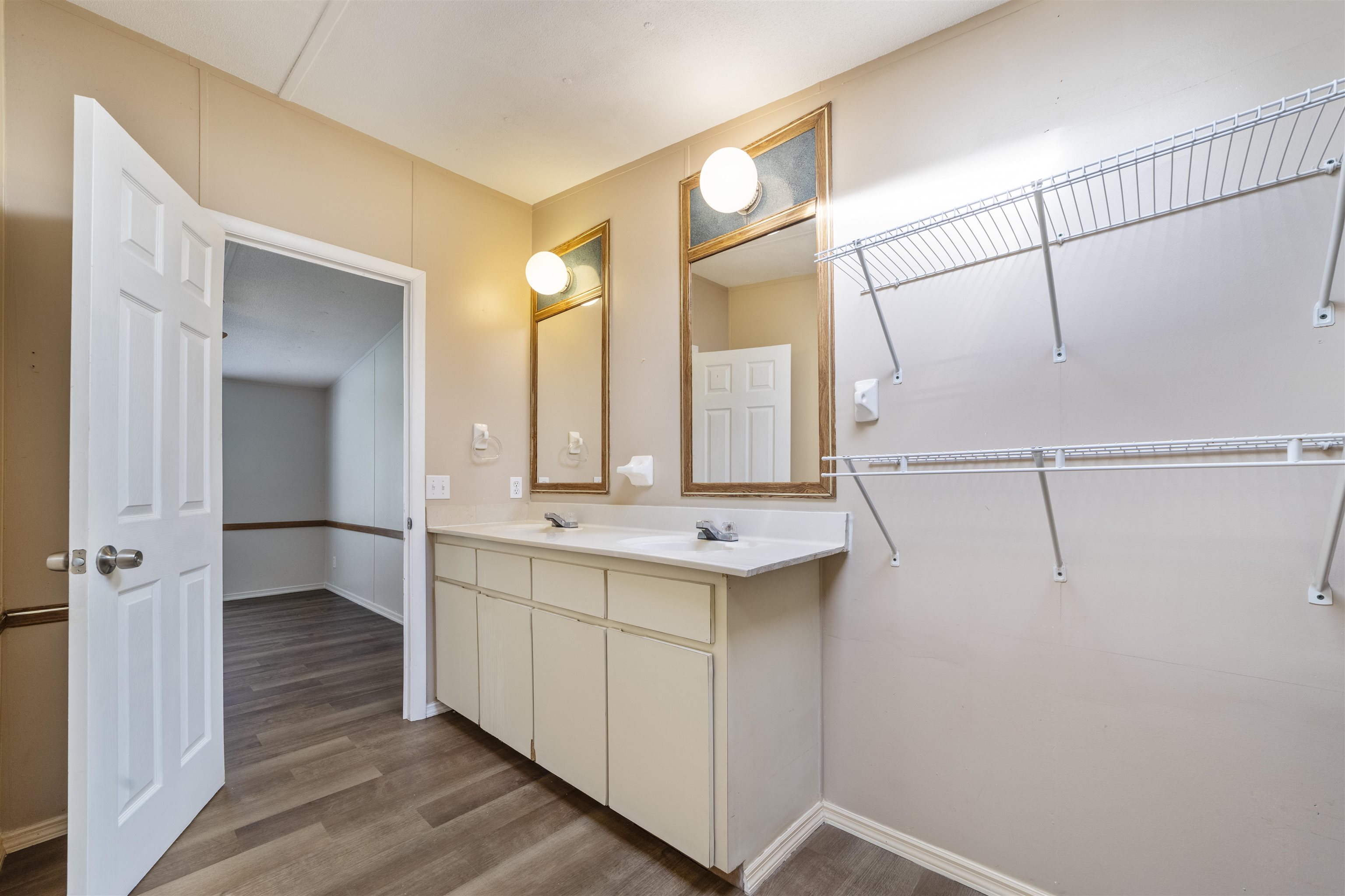 2905 County Road 214, Unit D St. Augustine, FL 32084 - Photo 7 of 46 a bathroom with a double vanity sink and mirror