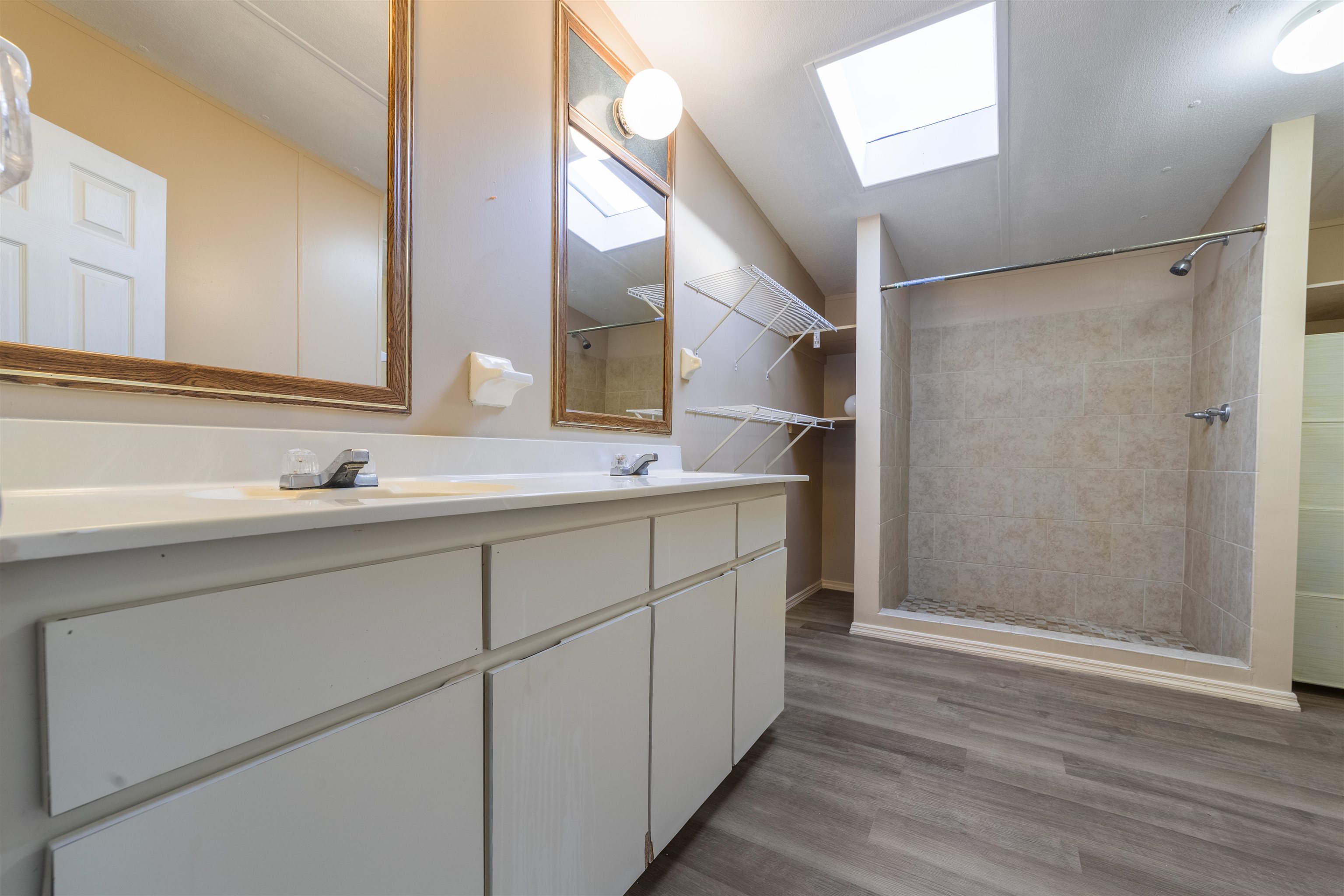 2905 County Road 214, Unit D St. Augustine, FL 32084 - Photo 9 of 46 a bathroom with a double vanity sink and mirror