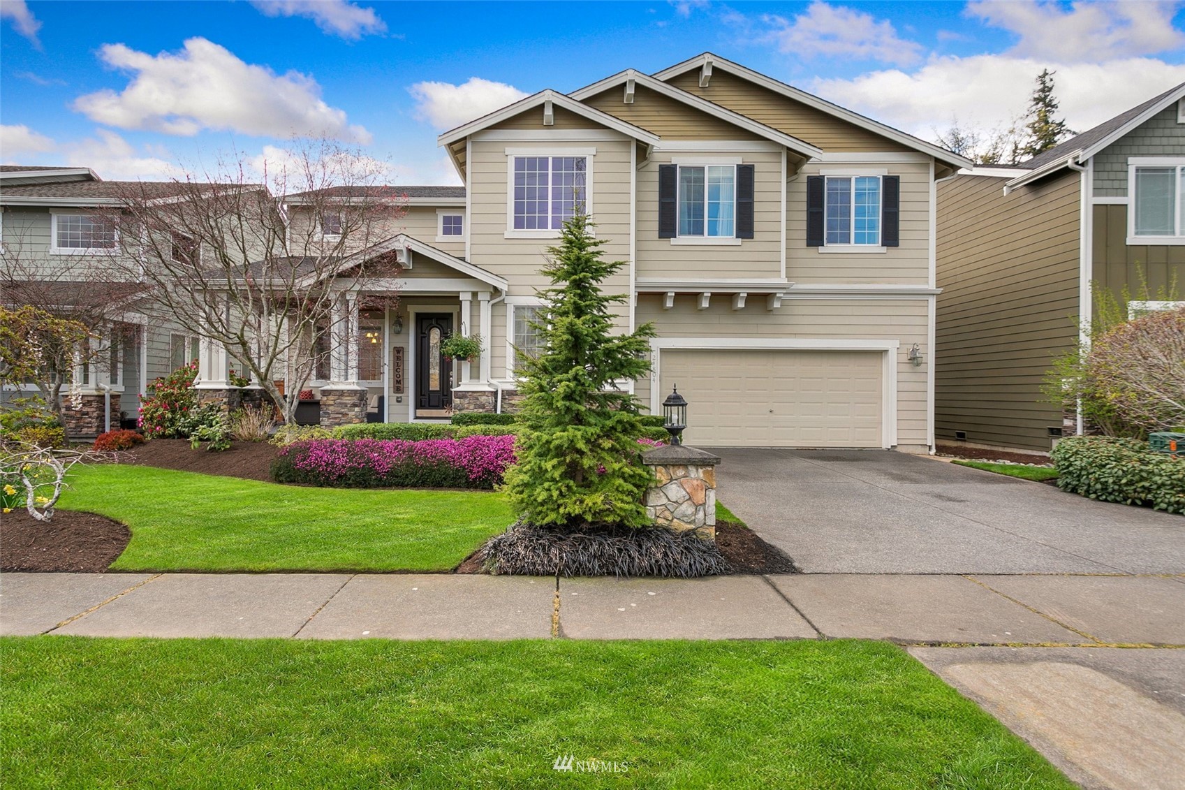 21804 42 Avenue Southeast Bothell, WA 98021 - Photo 1 of 33 a front view of a house with a garden and plants