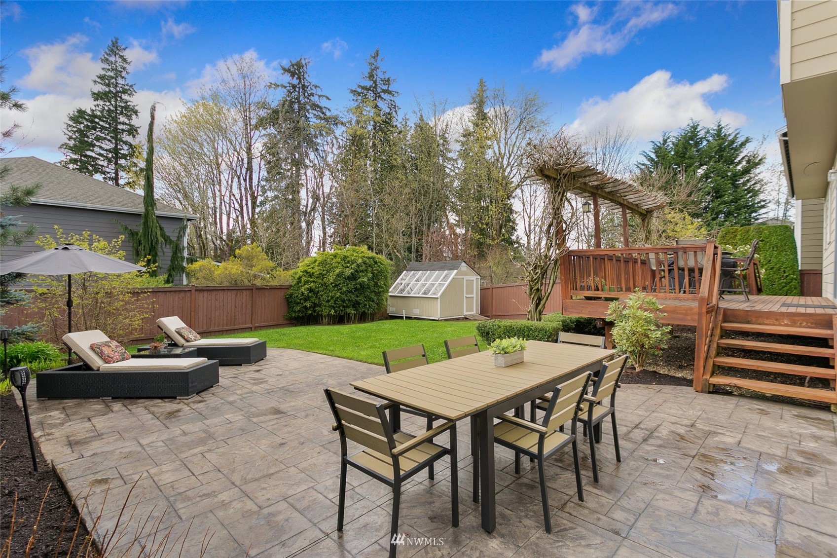 21804 42 Avenue Southeast Bothell, WA 98021 - Photo 14 of 33 a view of a patio with a table and chairs and potted plants