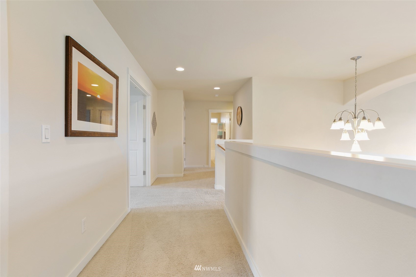 21804 42 Avenue Southeast Bothell, WA 98021 - Photo 16 of 33 a view of a hallway with wooden floor and chandelier