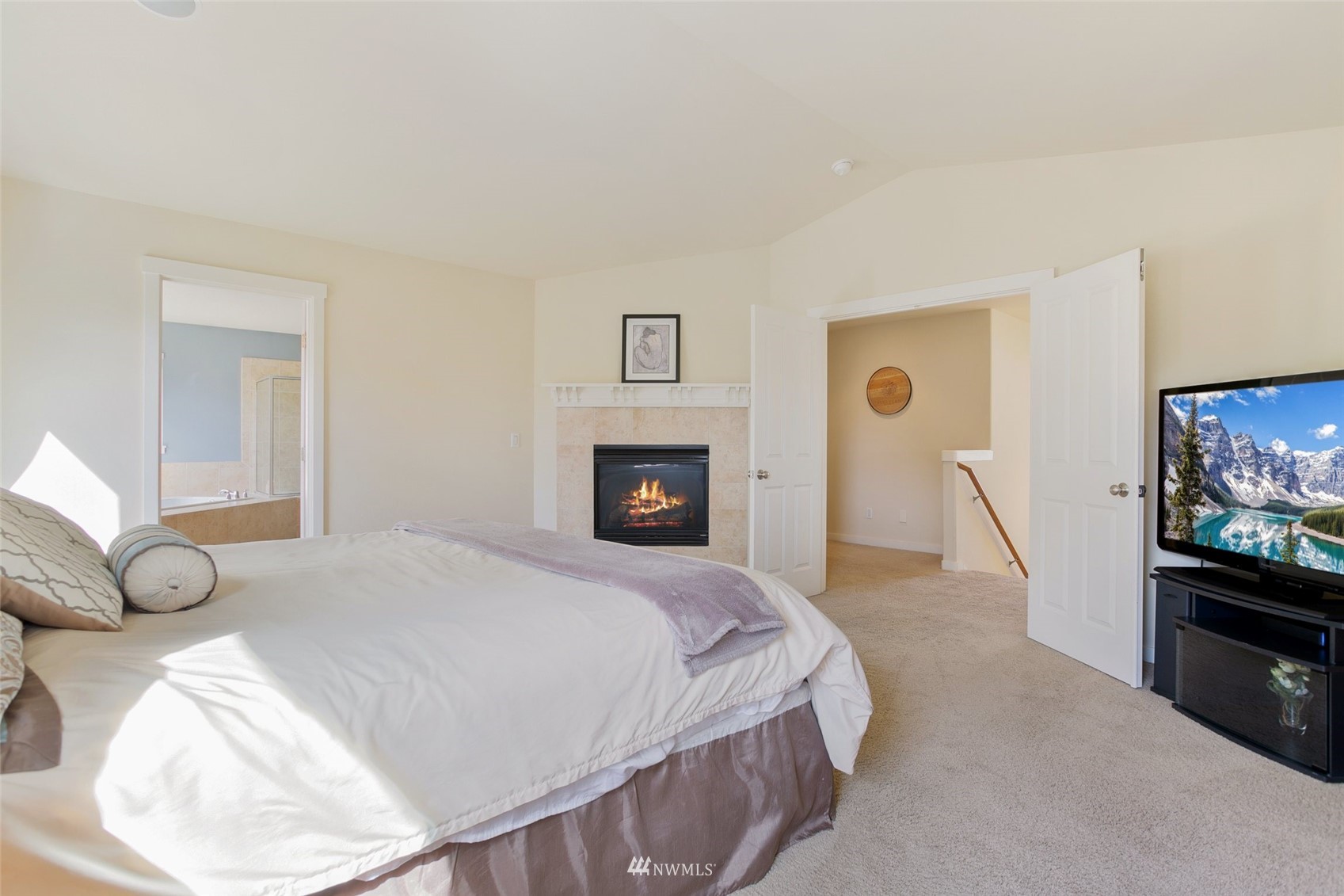 21804 42 Avenue Southeast Bothell, WA 98021 - Photo 18 of 33 a spacious bedroom with a bed and a flat screen tv