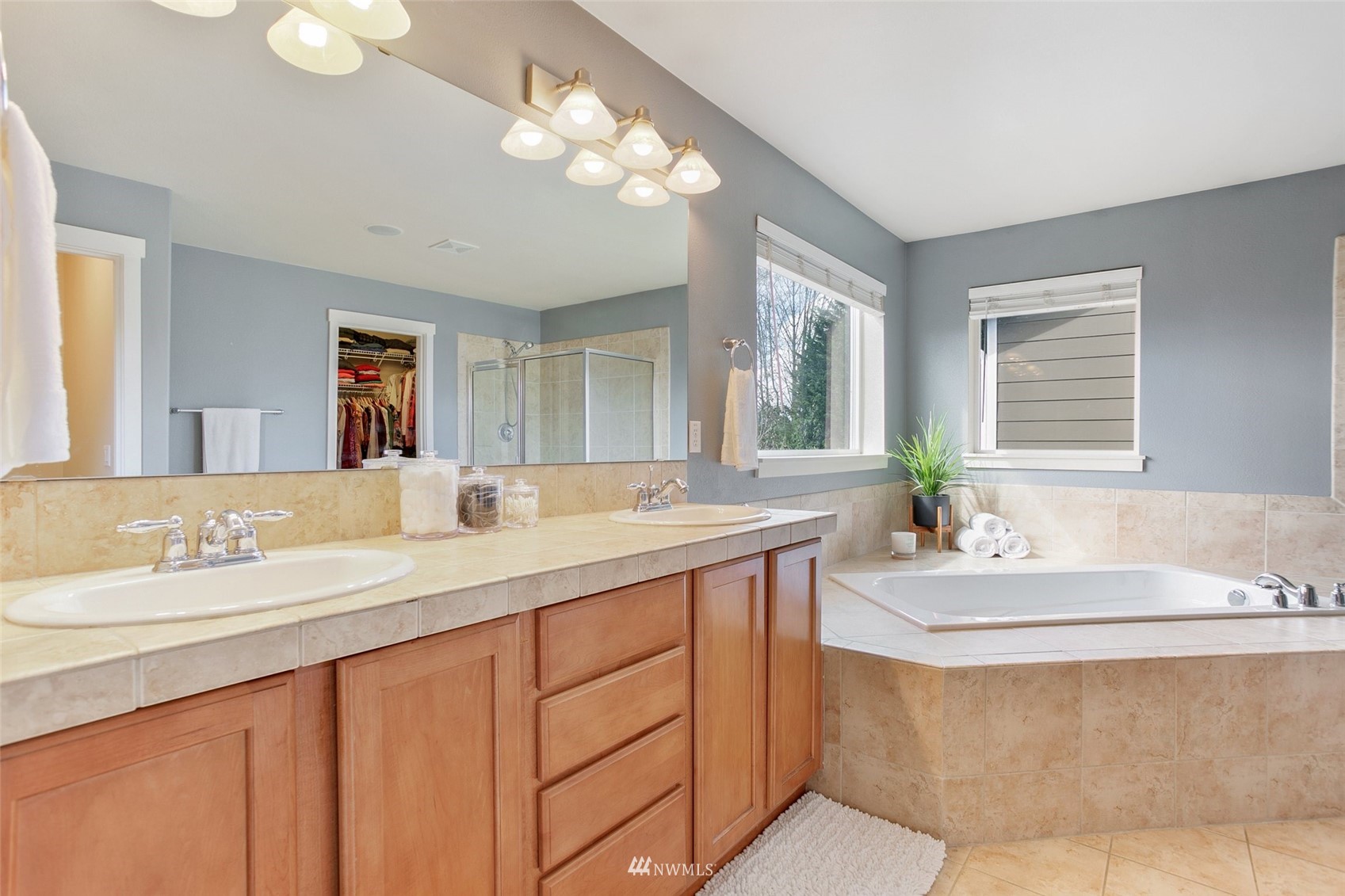 21804 42 Avenue Southeast Bothell, WA 98021 - Photo 19 of 33 a bathroom with double vanity sinks a vanity a lamp and a mirror