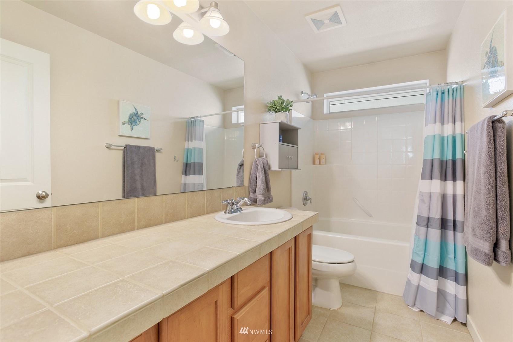 21804 42 Avenue Southeast Bothell, WA 98021 - Photo 23 of 33 a spacious bathroom with a granite countertop sink a toilet a mirror and shower