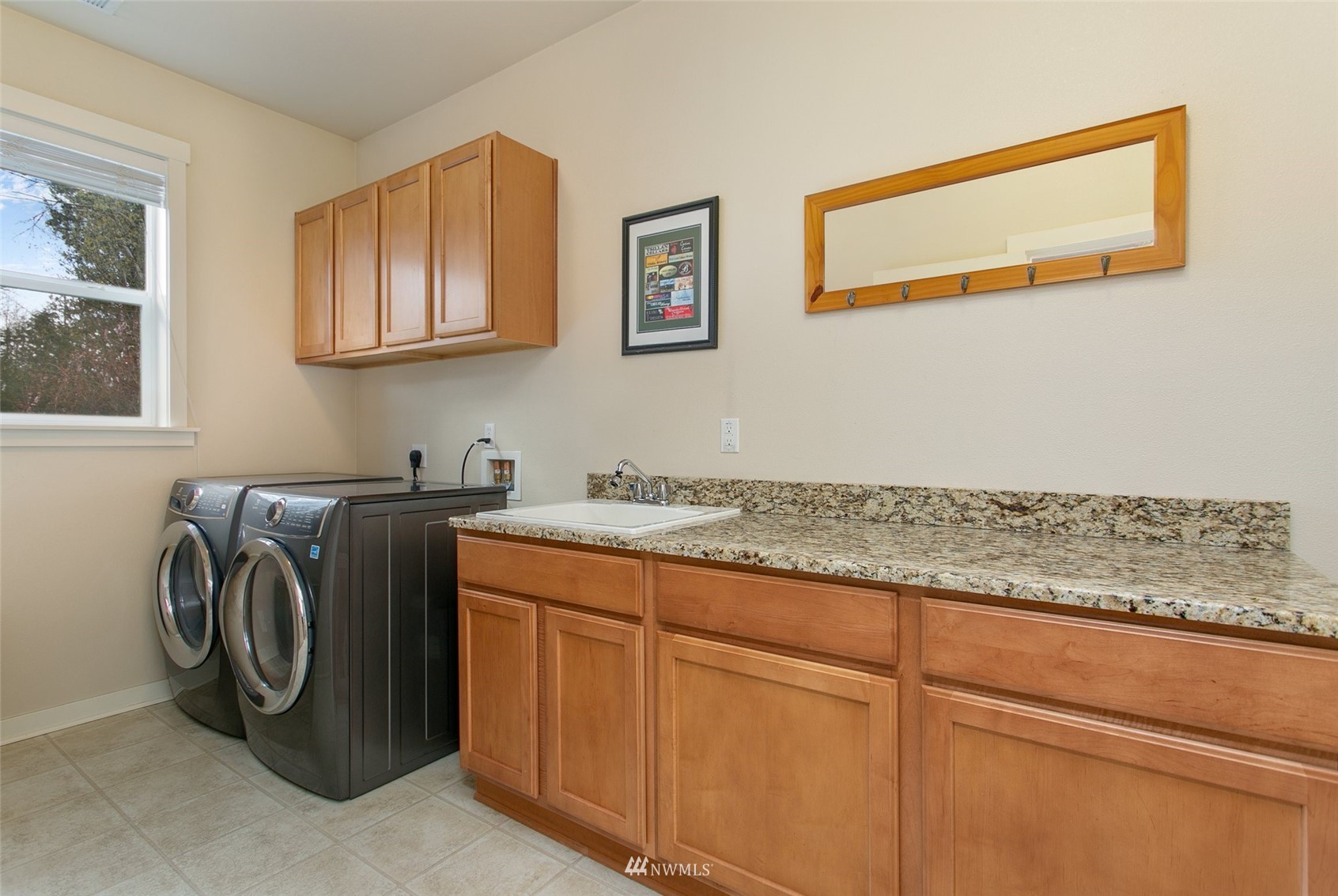 21804 42 Avenue Southeast Bothell, WA 98021 - Photo 26 of 33 a utility room with granite countertop cabinets and washer