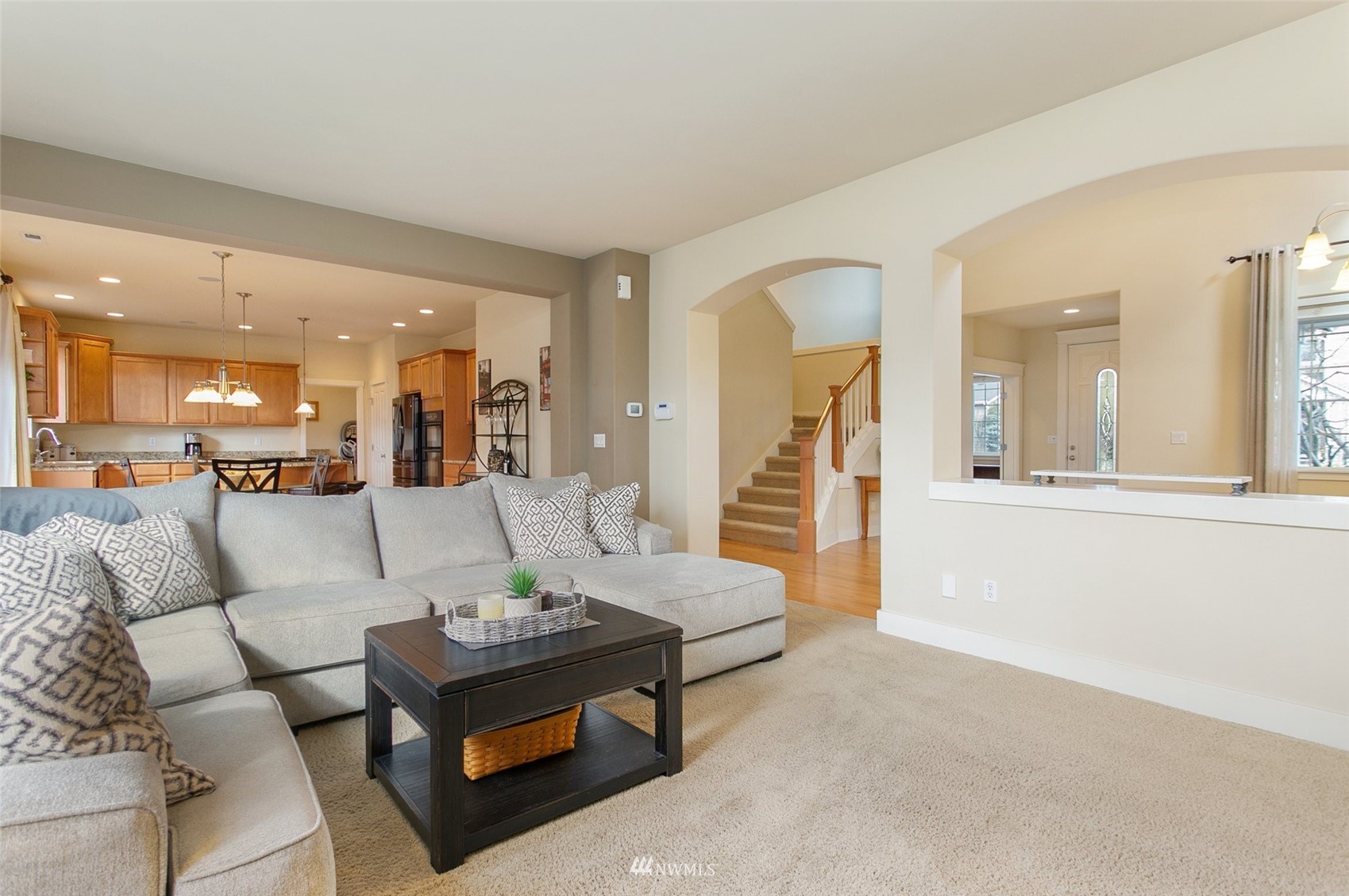21804 42 Avenue Southeast Bothell, WA 98021 - Photo 8 of 33 a living room with furniture and a large mirror next to a window