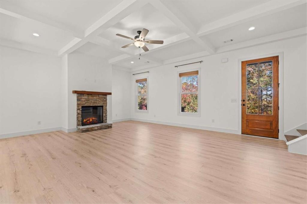 51 Post Oak Trace Villa Rica, GA 30180 - Photo 12 of 54 an empty room with windows fireplace and a chandelier fan