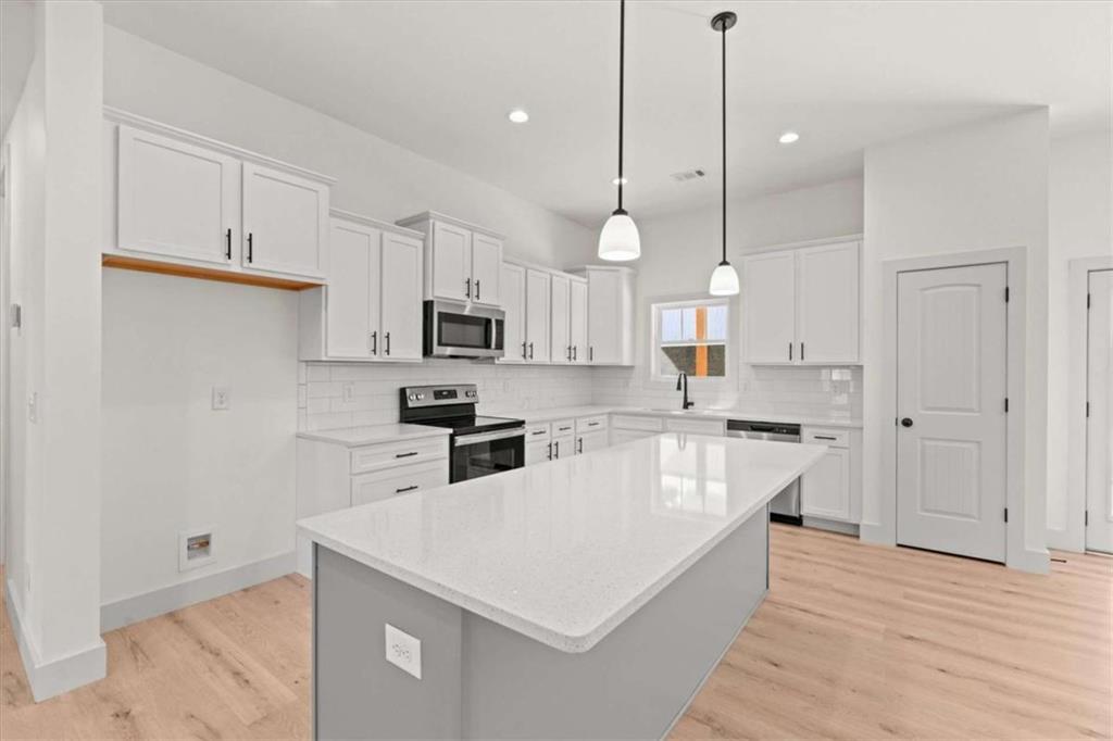 51 Post Oak Trace Villa Rica, GA 30180 - Photo 16 of 54 a kitchen with white cabinets and stainless steel appliances