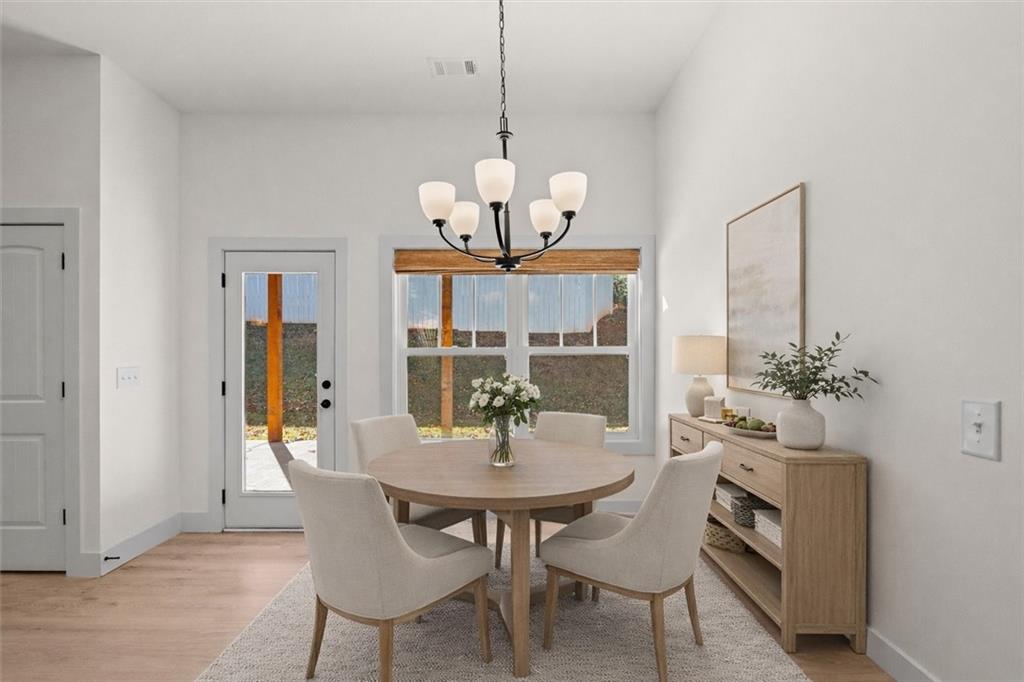 51 Post Oak Trace Villa Rica, GA 30180 - Photo 21 of 54 a dining room with furniture a chandelier and wooden floor