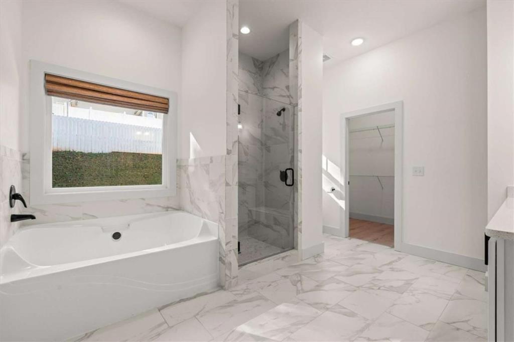 51 Post Oak Trace Villa Rica, GA 30180 - Photo 27 of 54 a bathroom with a bathtub and a shower