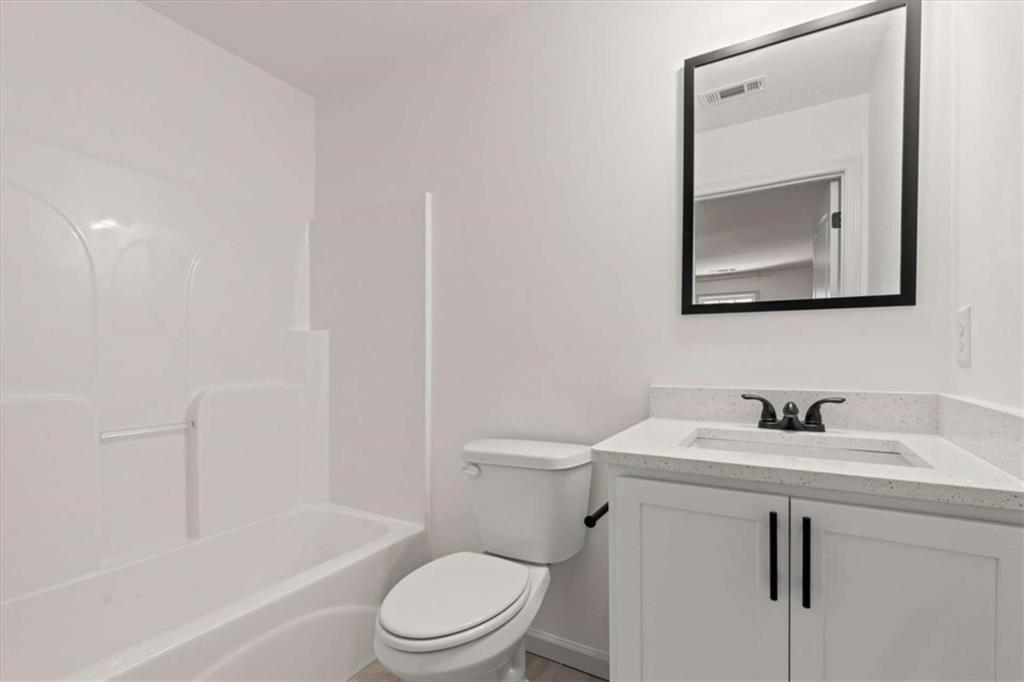 51 Post Oak Trace Villa Rica, GA 30180 - Photo 38 of 54 a bathroom with a toilet sink vanity tub and mirror