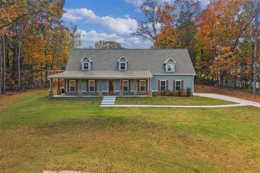 51 Post Oak Trace Villa Rica, GA 30180 - Photo 52 of 54 a front view of a house with a garden and swimming pool