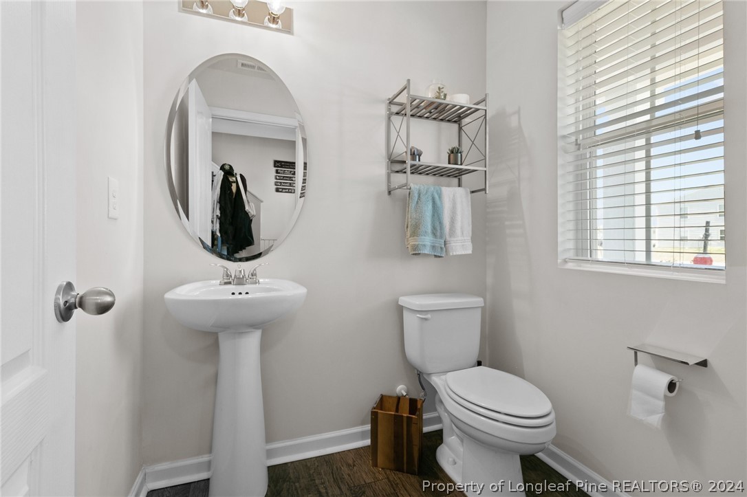 5942 Lowgrass Road Stedman, NC 28391 - Photo 11 of 28 a bathroom with a toilet sink and mirror