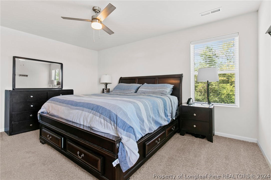 5942 Lowgrass Road Stedman, NC 28391 - Photo 12 of 28 a bedroom with a bed and window