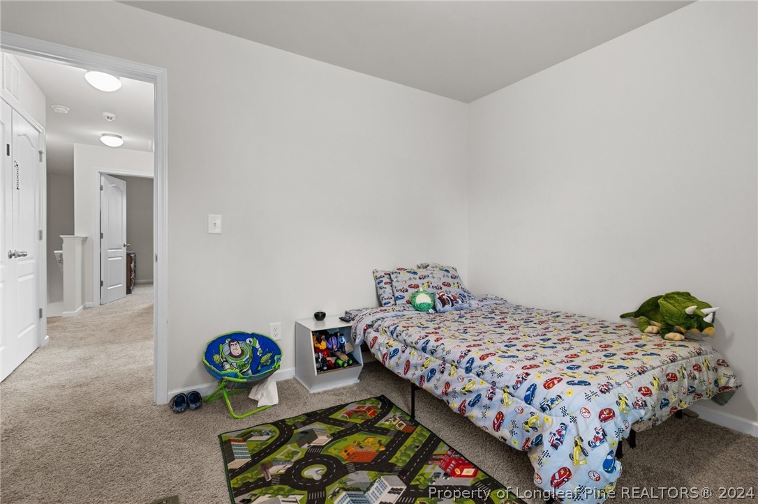 5942 Lowgrass Road Stedman, NC 28391 - Photo 17 of 28 a bedroom with bed and a window
