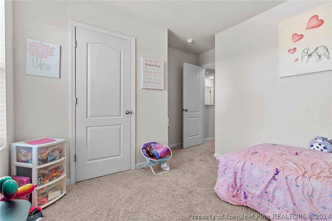 5942 Lowgrass Road Stedman, NC 28391 - Photo 19 of 28 a bedroom with a bed and a couch