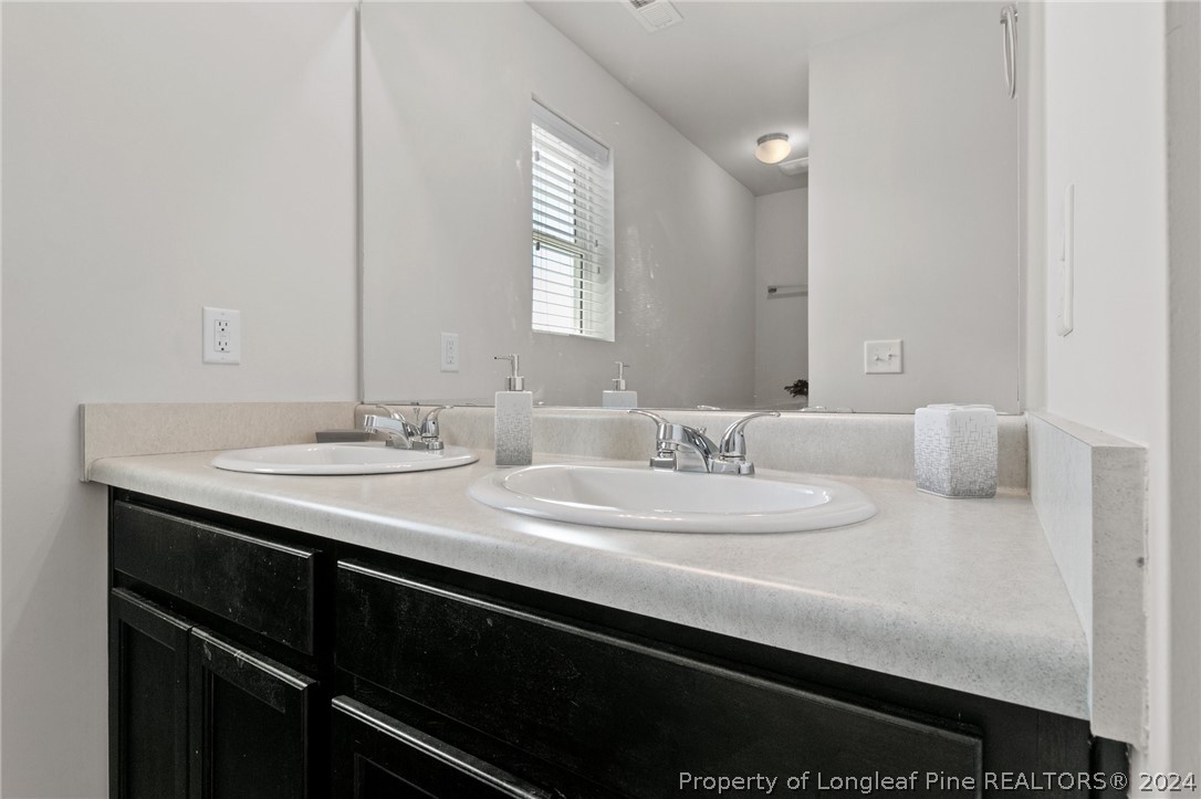 5942 Lowgrass Road Stedman, NC 28391 - Photo 20 of 28 a bathroom with a sink and a mirror