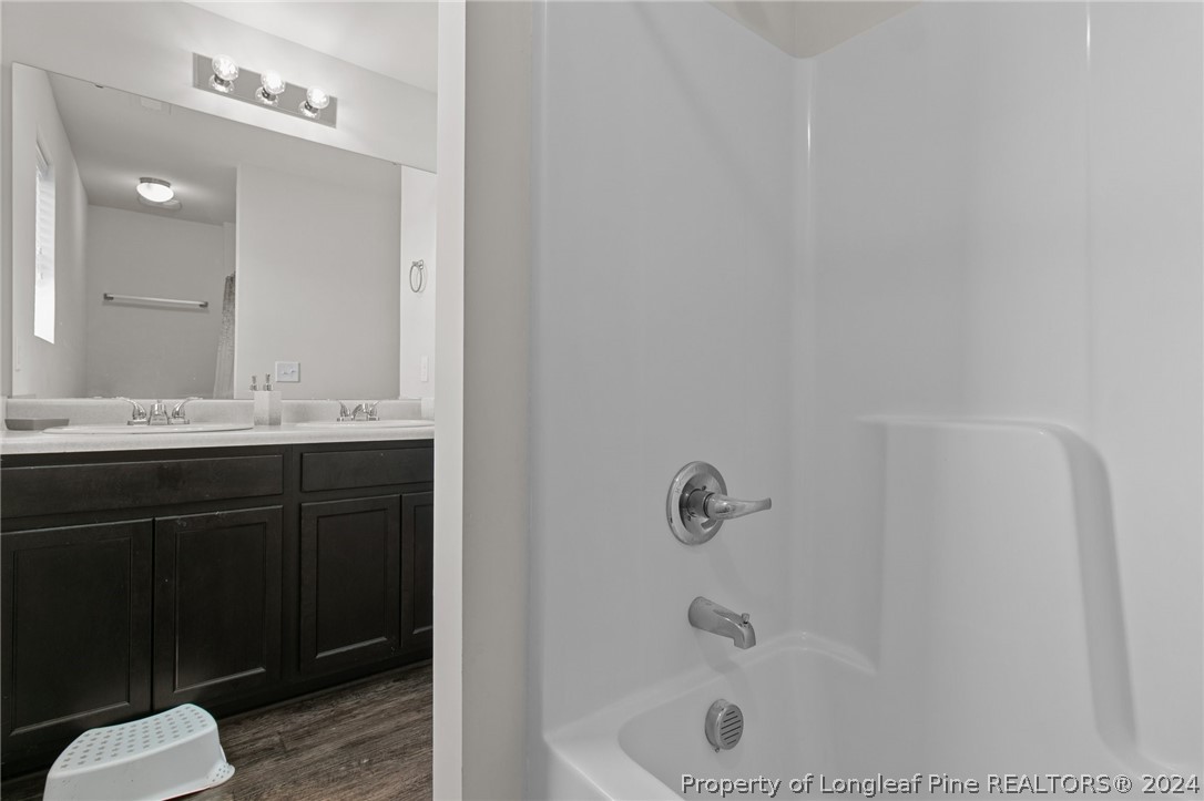 5942 Lowgrass Road Stedman, NC 28391 - Photo 21 of 28 a bathroom with a sink a toilet a shower and mirror