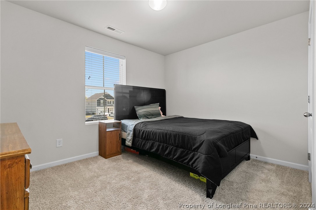 5942 Lowgrass Road Stedman, NC 28391 - Photo 22 of 28 a bed sitting in a room next to a window