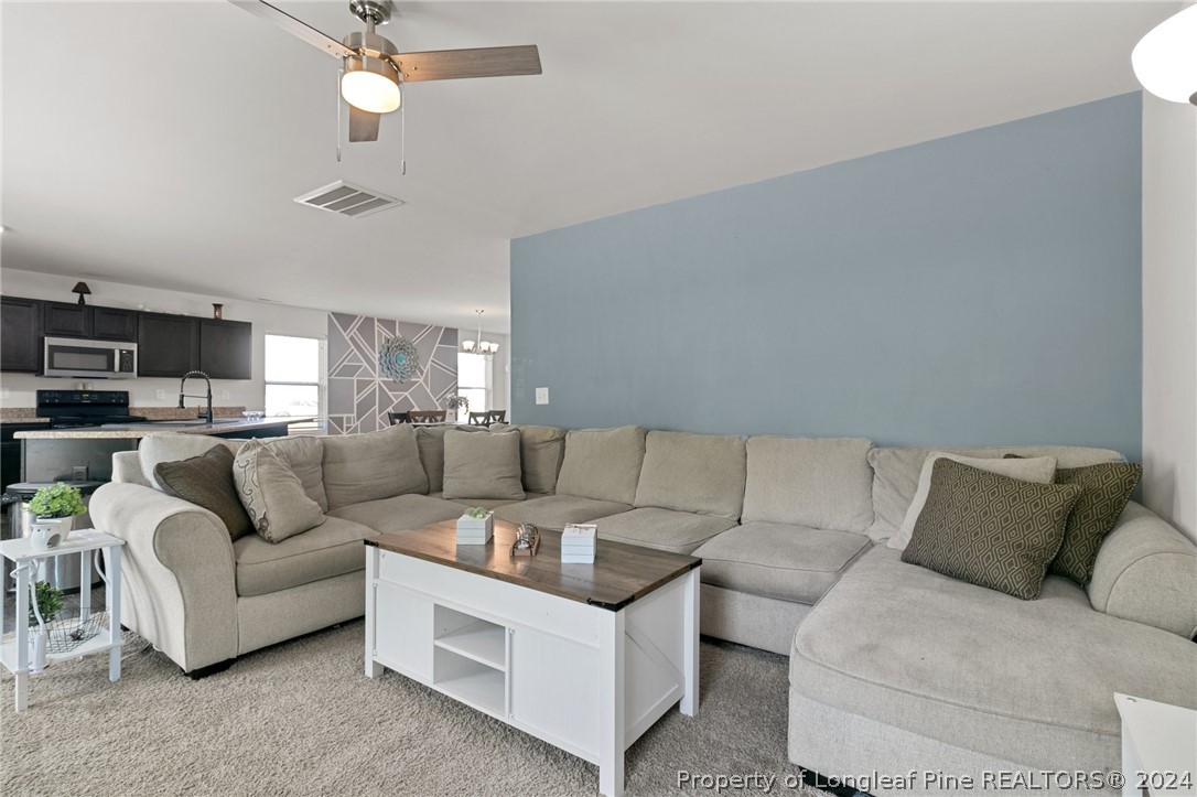 5942 Lowgrass Road Stedman, NC 28391 - Photo 10 of 28 a living room with furniture and a view of kitchen