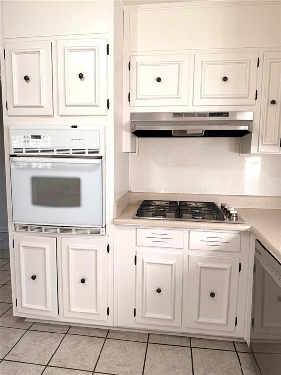 4359 Parkview Drive Lithia Springs, GA 30122 - Photo 5 of 23 a kitchen with white cabinets and appliances
