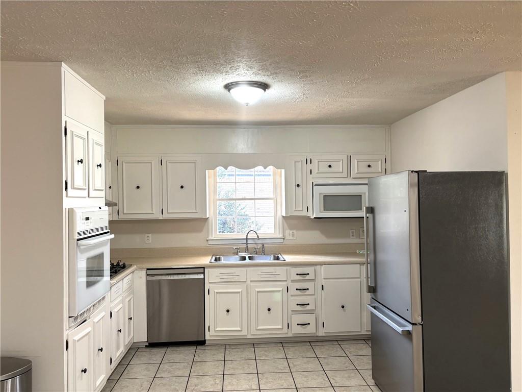 4359 Parkview Drive Lithia Springs, GA 30122 - Photo 8 of 23 a kitchen with a refrigerator a sink and a stove top oven