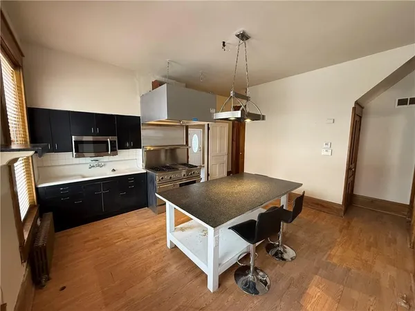 a kitchen with a sink appliances and cabinets
