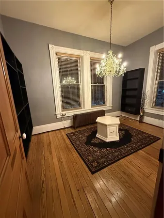 a floor to ceiling window and wooden floor