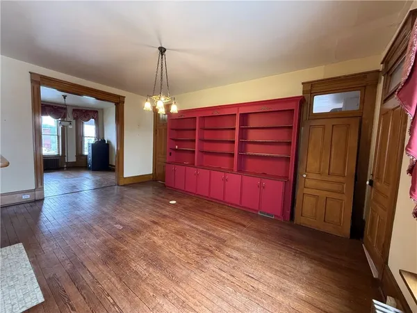 a view of a room with wooden floor and windows