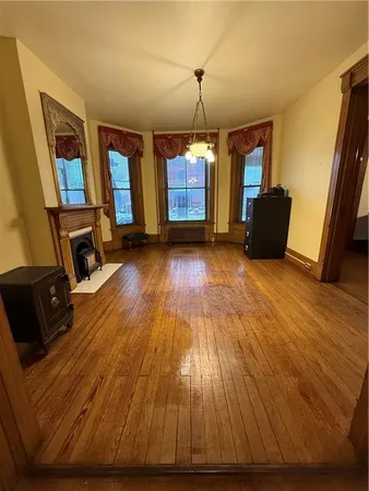 a view of a livingroom with wooden floor and furniture