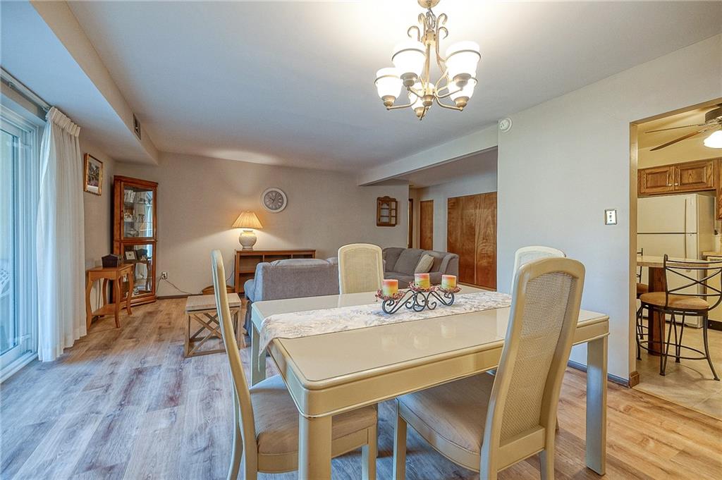551 Sloop Road, Unit 53 Pittsburgh, PA 15237 - Photo 6 of 21 a dining room with furniture a chandelier and wooden floor