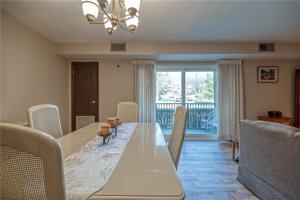 551 Sloop Road, Unit 53 Pittsburgh, PA 15237 - Photo 7 of 21 a living room with furniture a chandelier and wooden floor