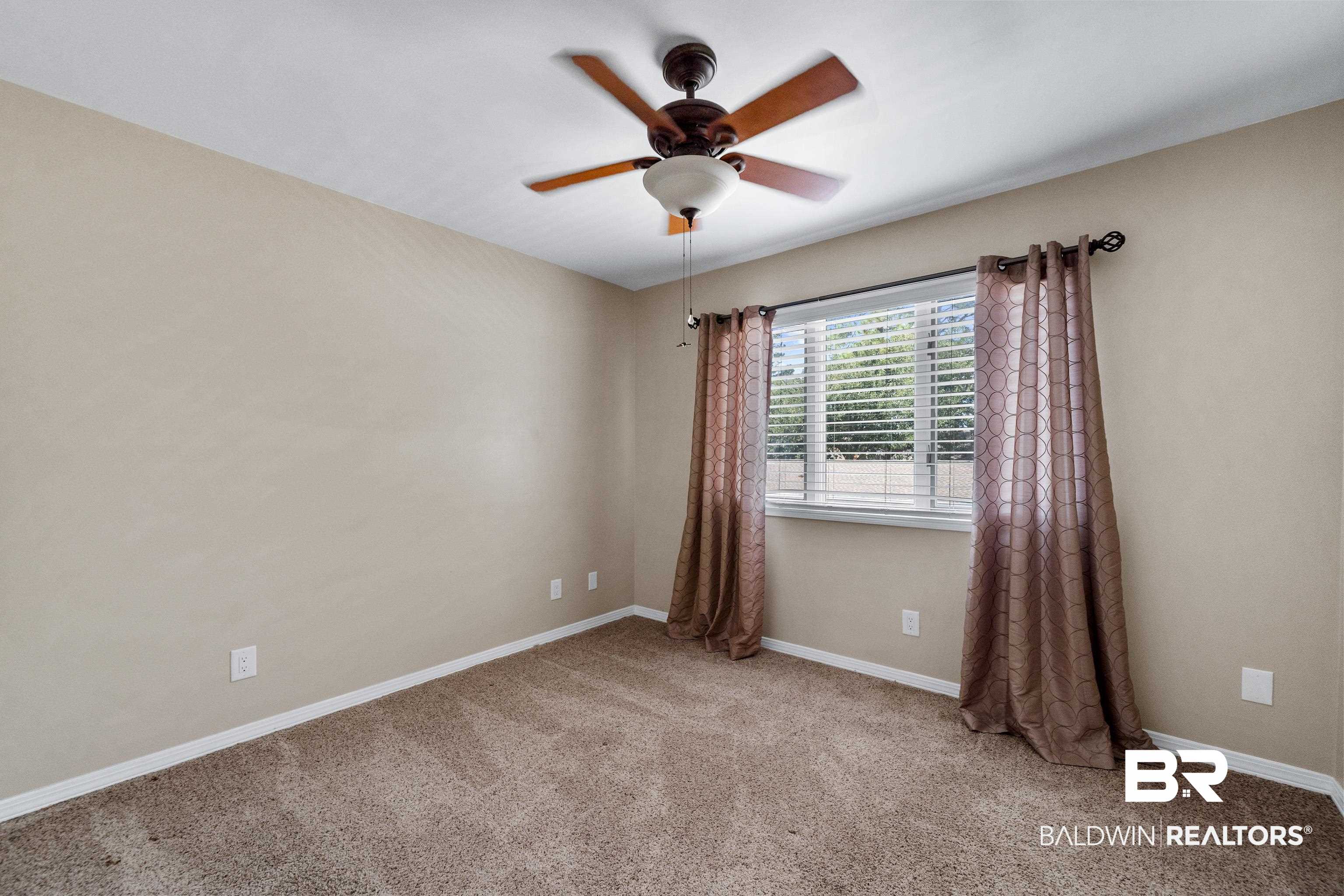 1701 Regency Road, Unit 111 Gulf Shores, AL 36542 - Photo 21 of 29 Carpeted empty room featuring ceiling fan