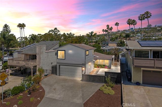 a view of a house with outdoor space and sitting area