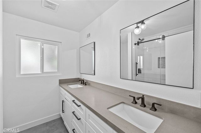 a bathroom with a shower and a sink