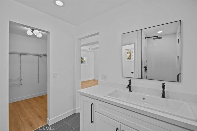 a view of empty room with wooden floor and window