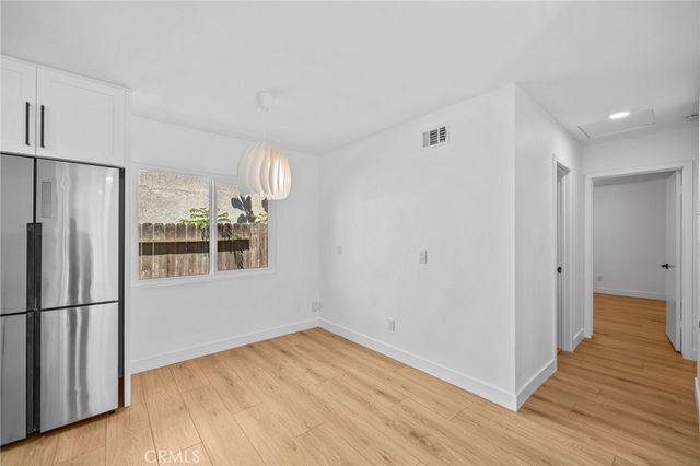 a kitchen with stainless steel appliances a refrigerator and a stove top oven