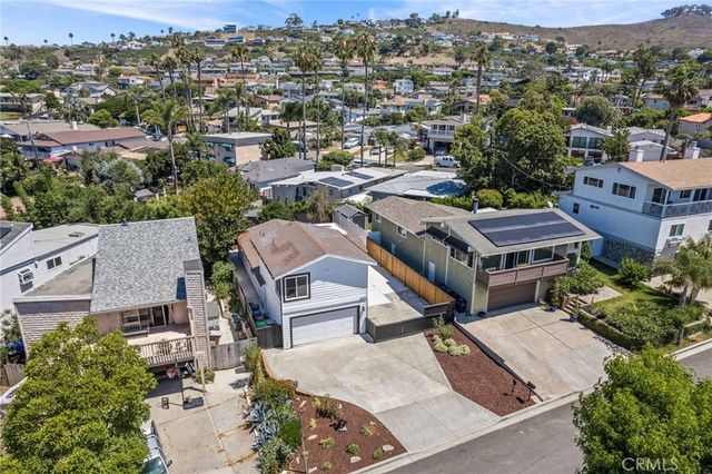 a bedroom with a bed mirror and a window