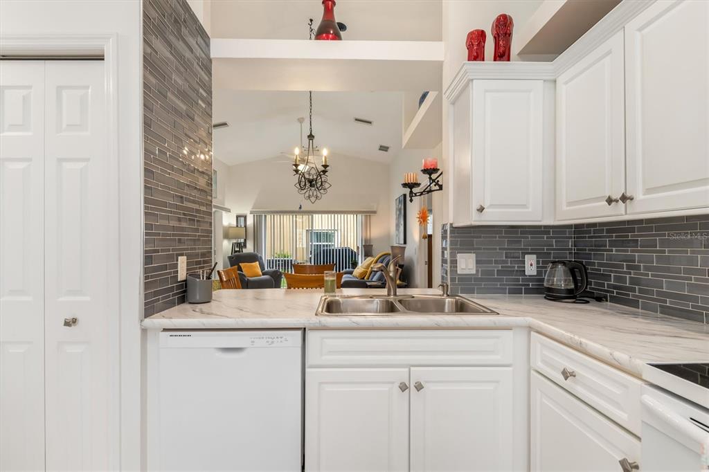 24167 Buckingham Way Punta Gorda, FL 33980 - Photo 13 of 42 a kitchen with a sink and cabinets