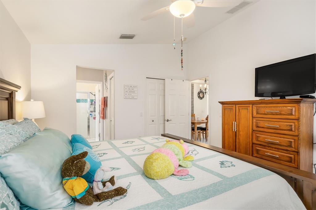 24167 Buckingham Way Punta Gorda, FL 33980 - Photo 19 of 42 a bedroom with a bed and a flat screen tv